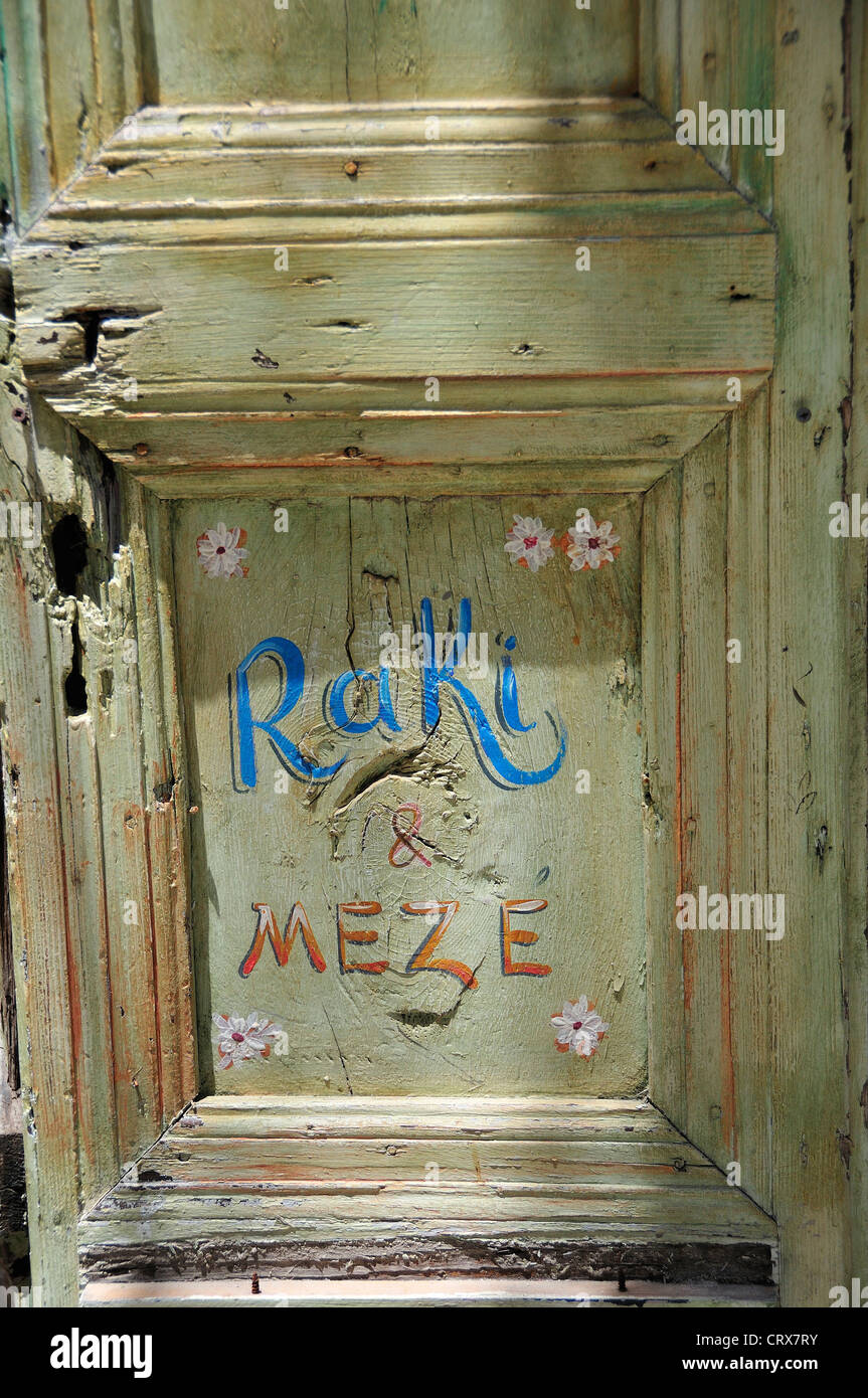 Old rustic door to restaurant in the town of Rethymnon, Crete, Greece Stock Photo