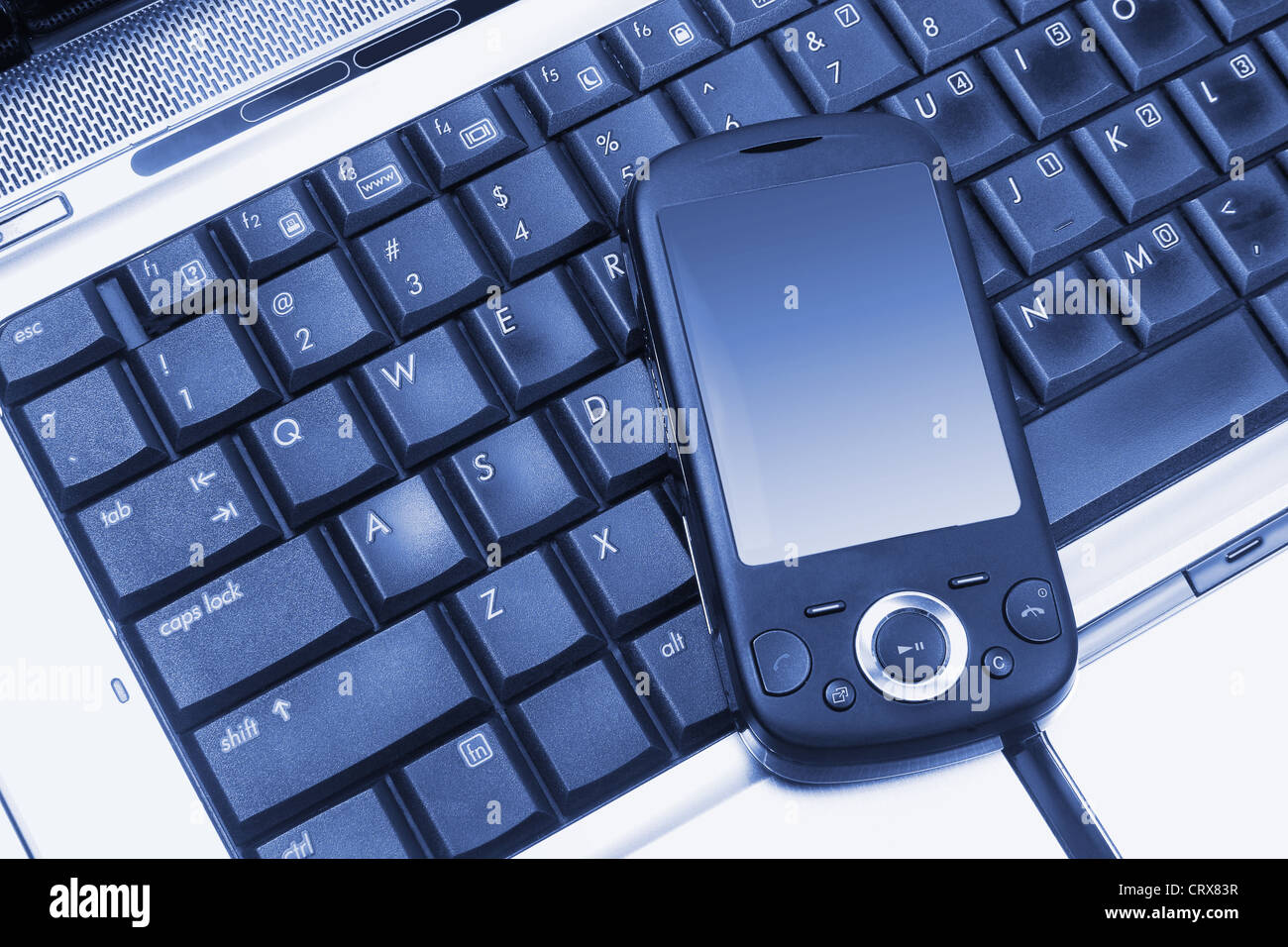 Smart Phone on Laptop Computer Stock Photo - Alamy