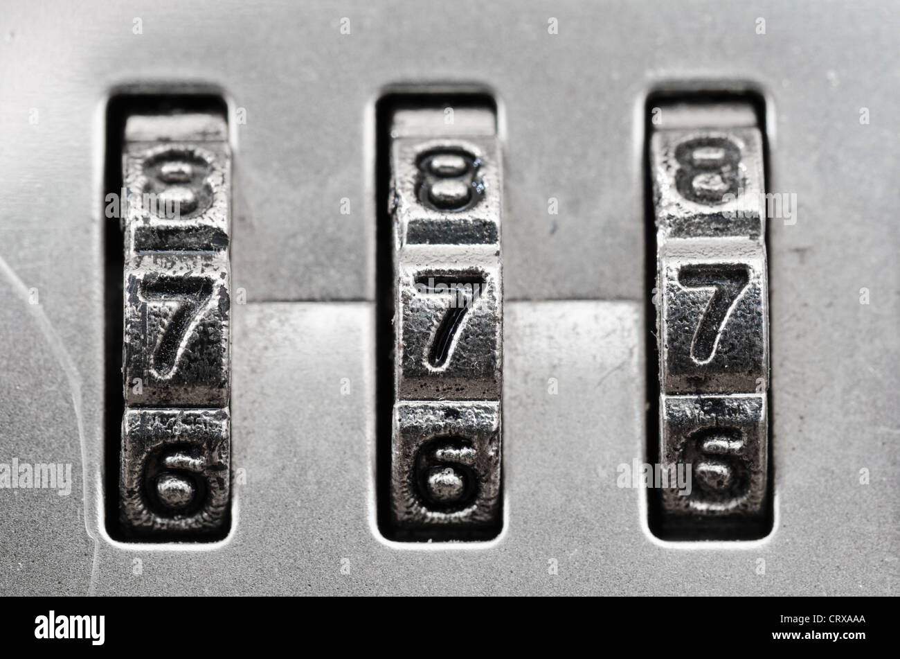 Macro of combination lock - dials set to 777,  Shallow DOF Stock Photo