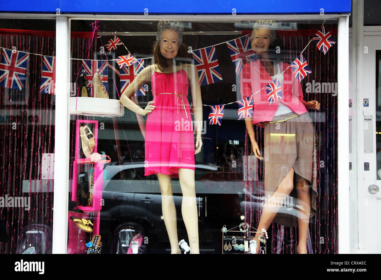 Shop Window With Union Jack Bunting And Queen Elizabeth II Face Masks On Mannequins Celebrating The Diamond Jubilee Stock Photo