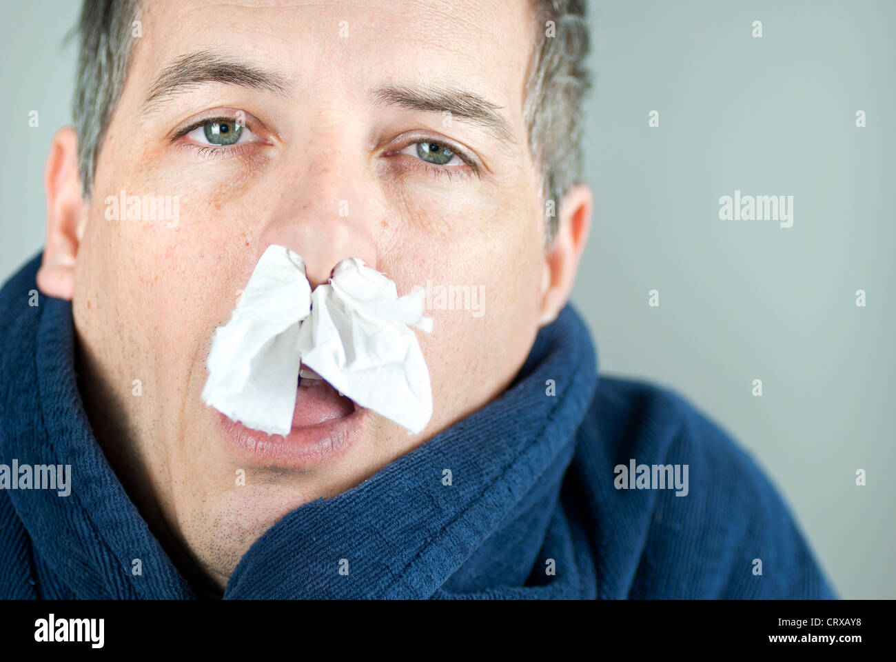 Close-up of a man with tissue in his nose. Stock Photo