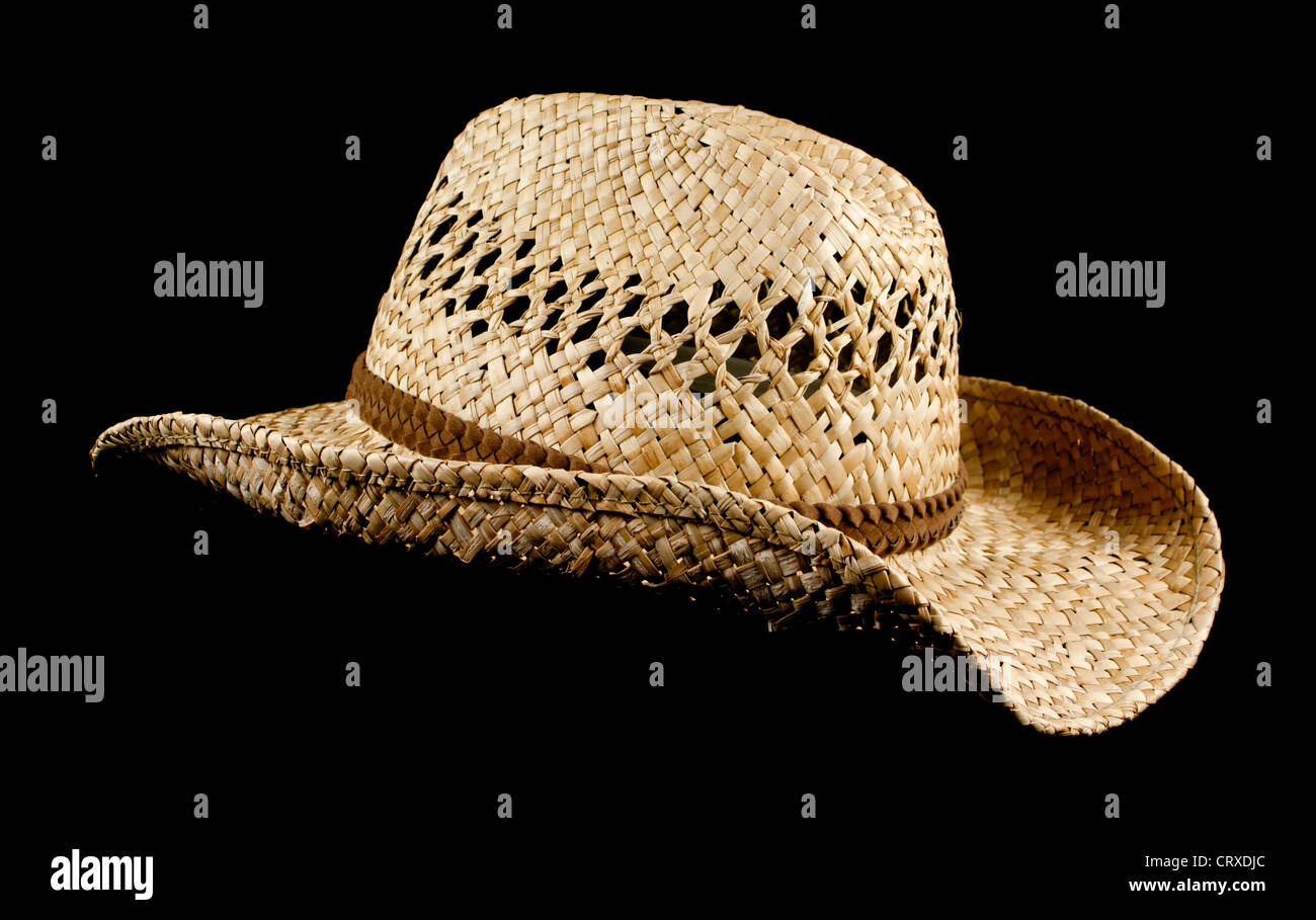 Natural brown straw sun hat isolated on pure black background with copy ...