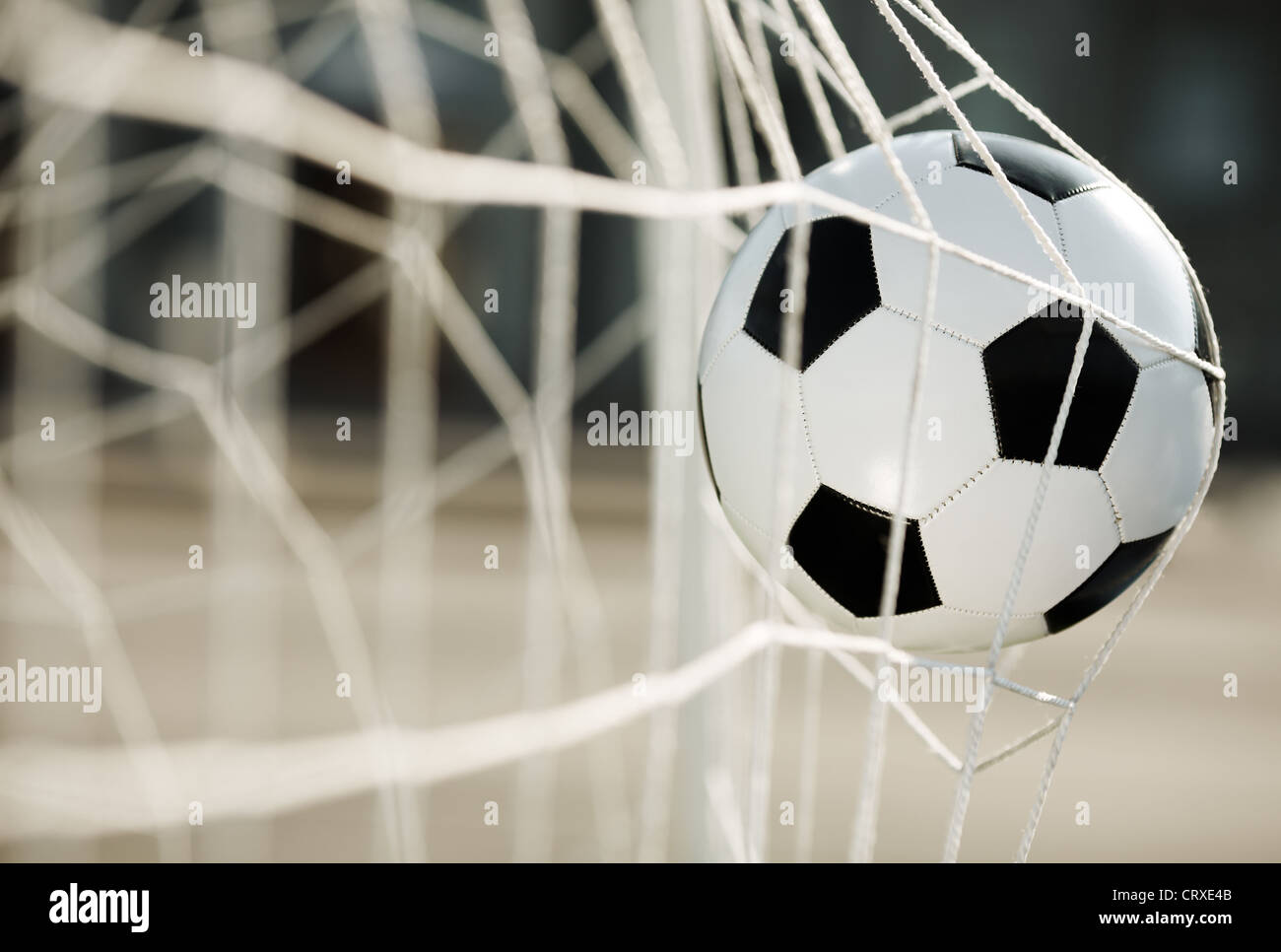 Soccer ball going into goal net Stock Photo