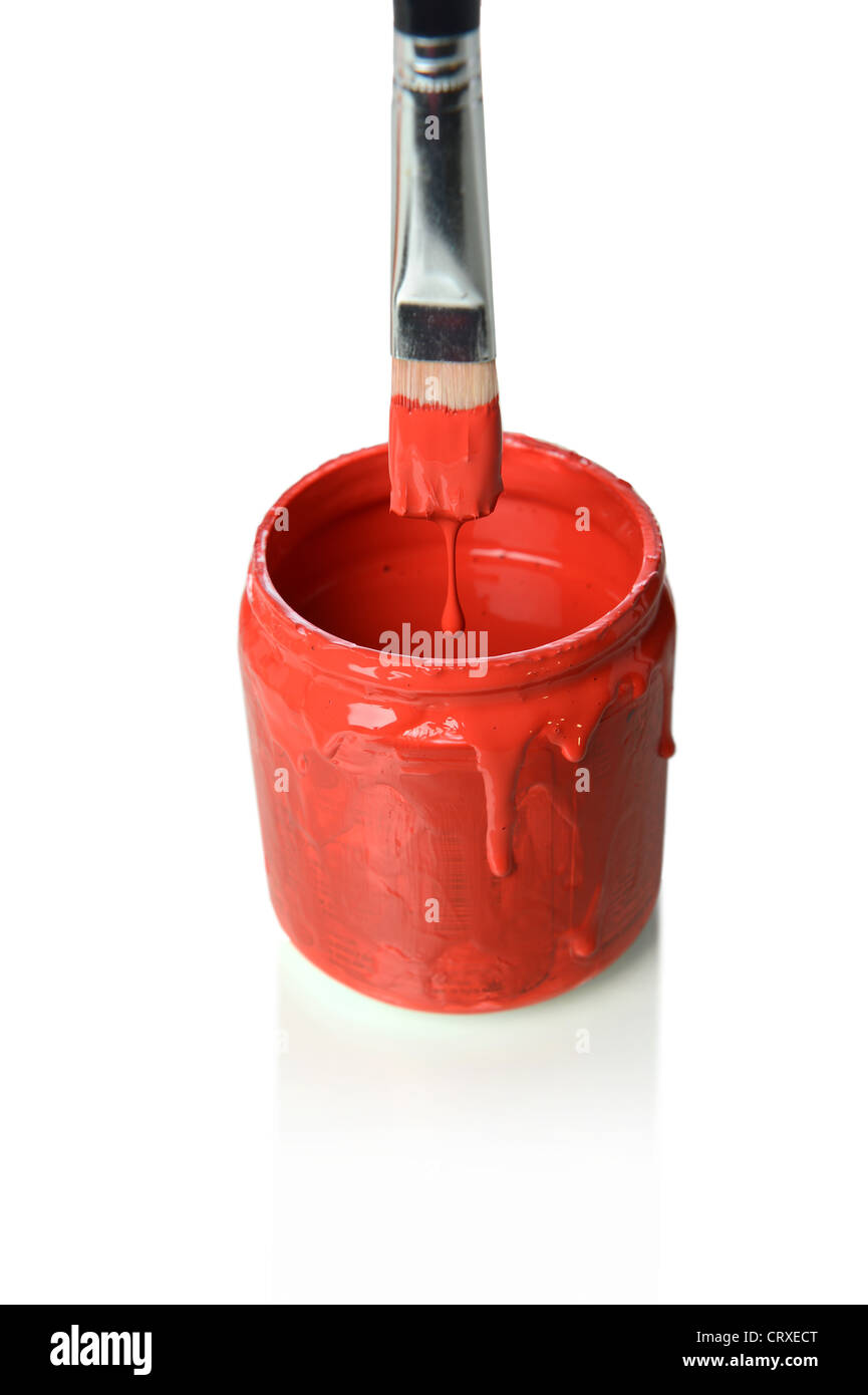 Paintbrush dripping red paint into can isolated over white background Stock Photo