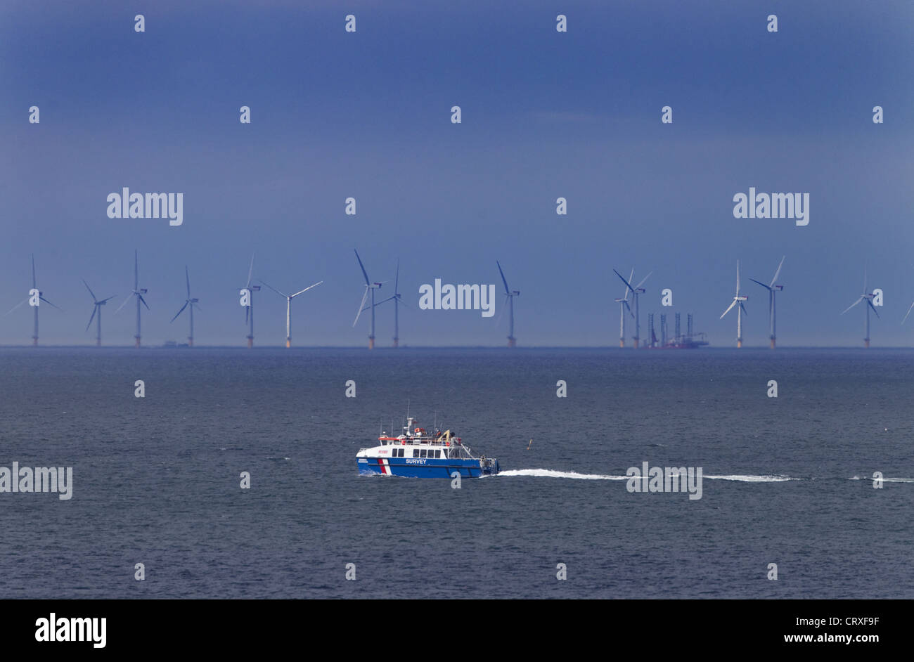 Survey vessel going past Sheringham Wind Farm from West Runton Norfolk Summer Stock Photo