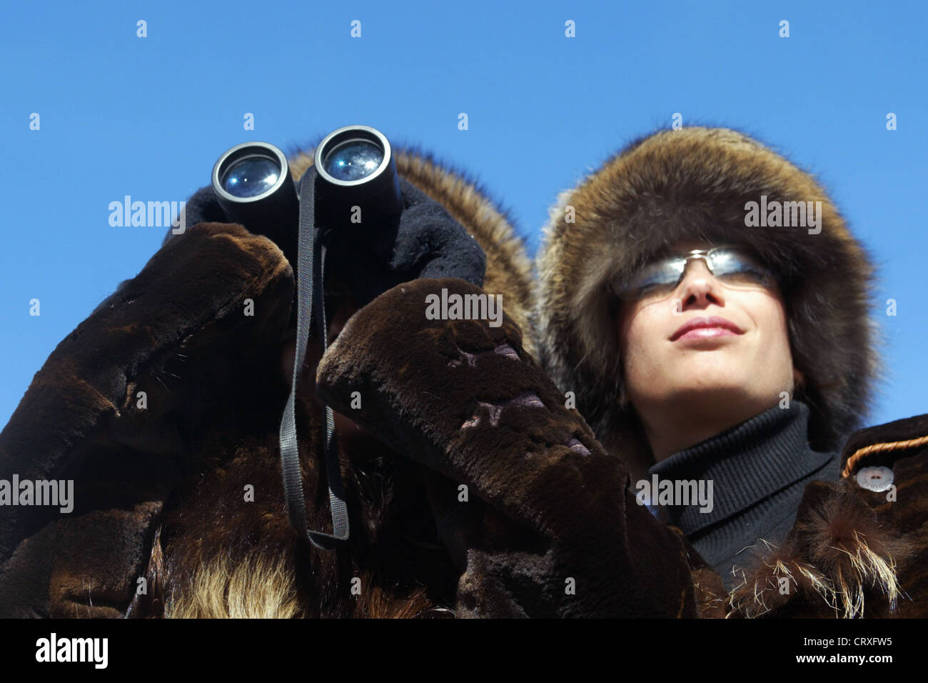 Two women with binoculars at the races Stock Photo