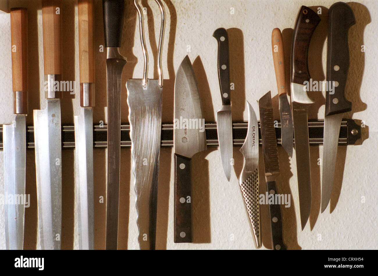 Many kitchen knives on strip Stock Photo Alamy