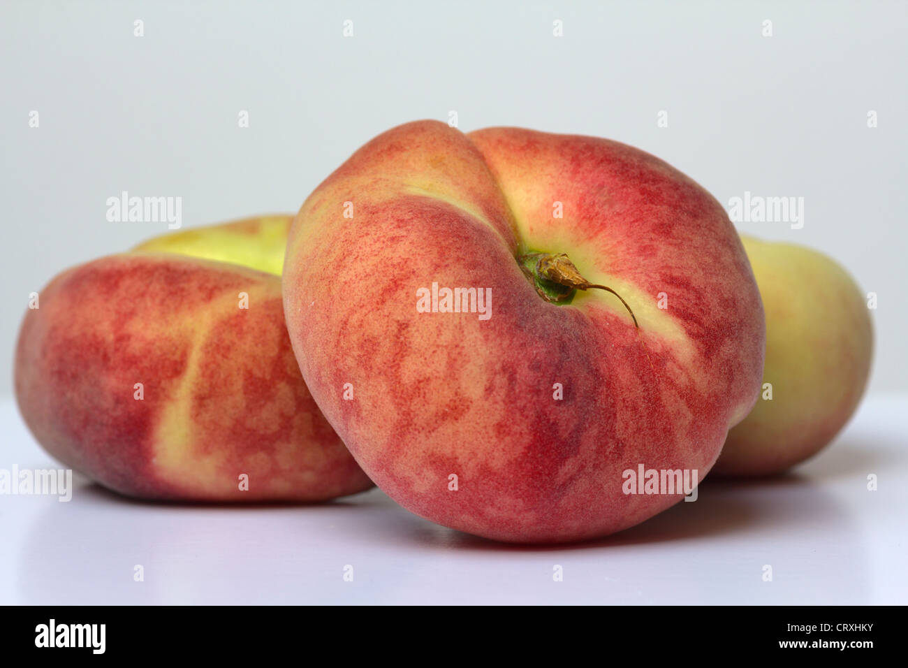 Three flat peaches Stock Photo Alamy