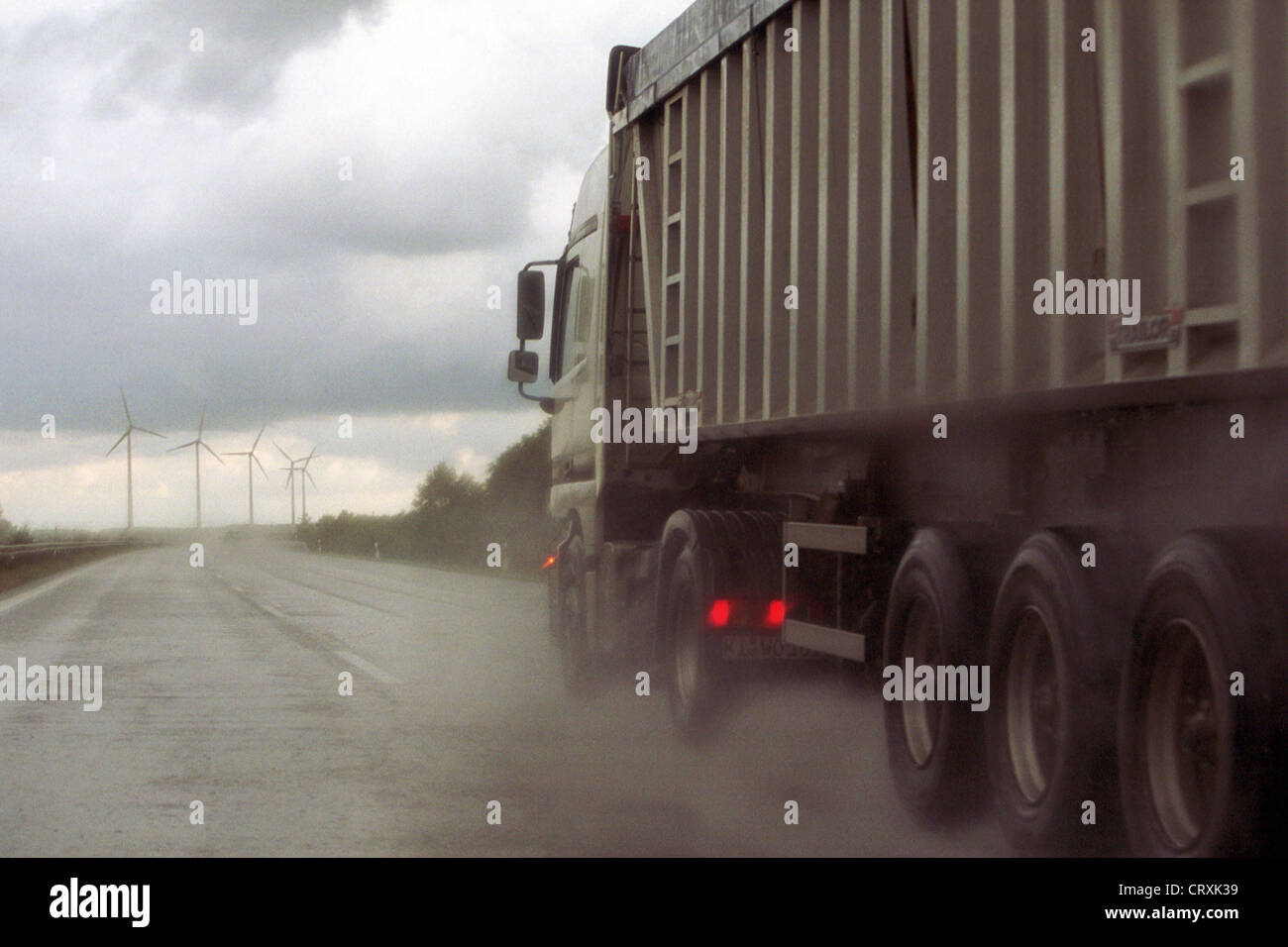 A truck on a rain-slicked highway Stock Photo