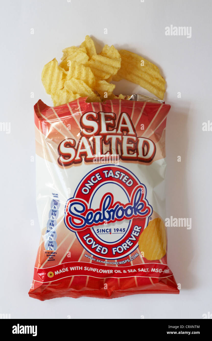 packet of Sea Salted once tasted Seabrook loved forever packet of crisps with packet opened and contents spilled spilt isolated on white background Stock Photo