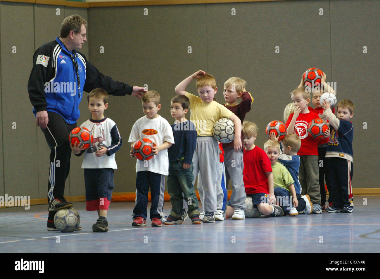 A group of children with their coach during football training Stock Photo