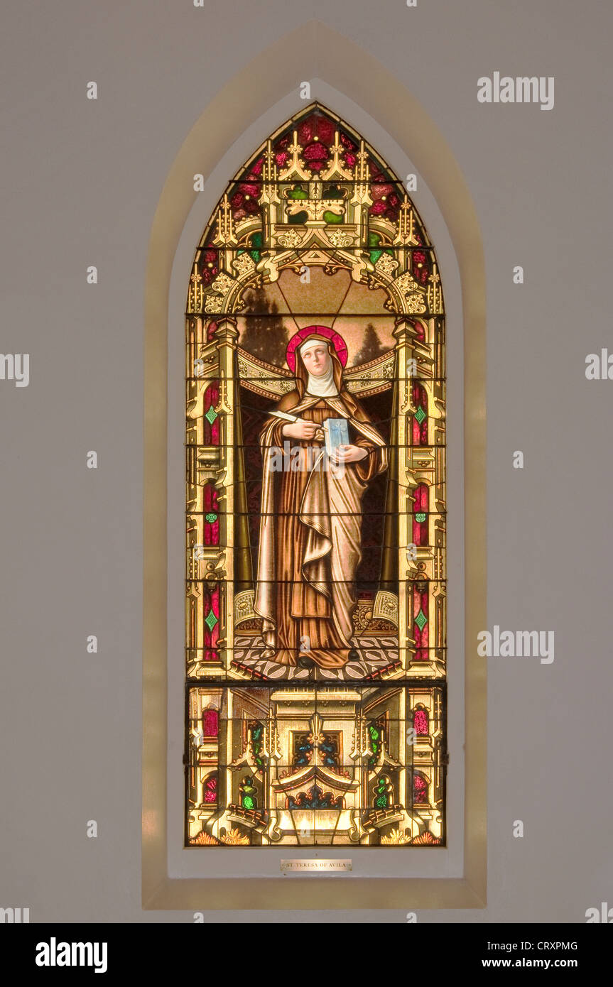 St. Theresa of Avila, stained glass window in St. Louis Catholic Church, built 1870, in Castroville, Texas, USA Stock Photo
