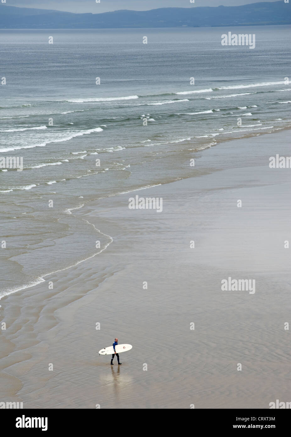 Lone surfer on the beach at Bundoran, County Donegal. Stock Photo