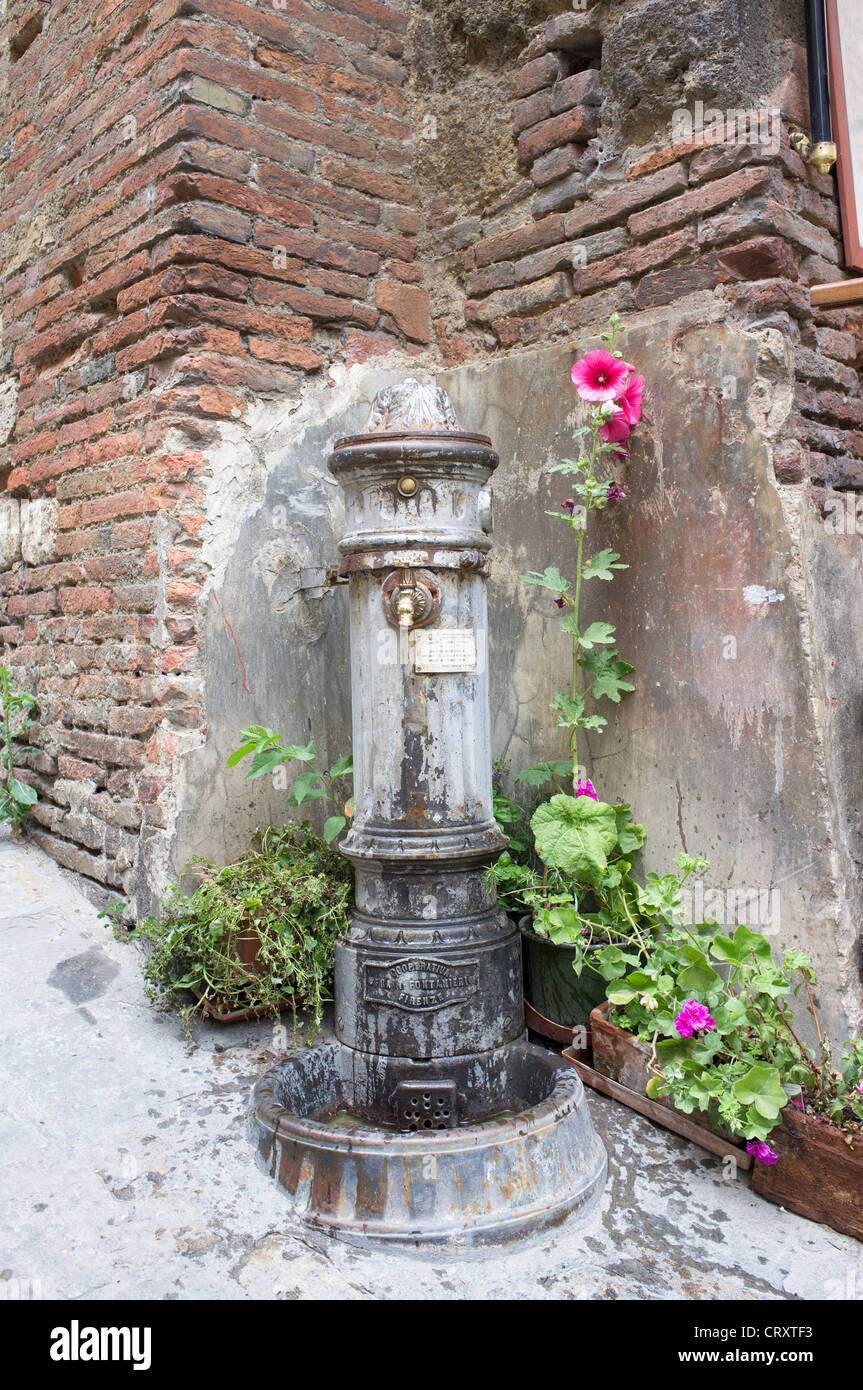 Old drinking fountain in the street in Montepulciano Italy Stock Photo