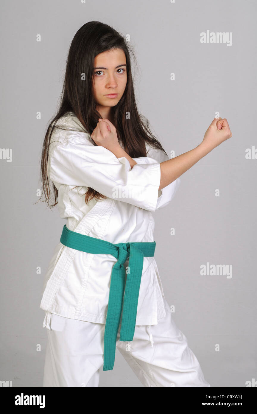 girl in Karate moves on grey background Stock Photo - Alamy