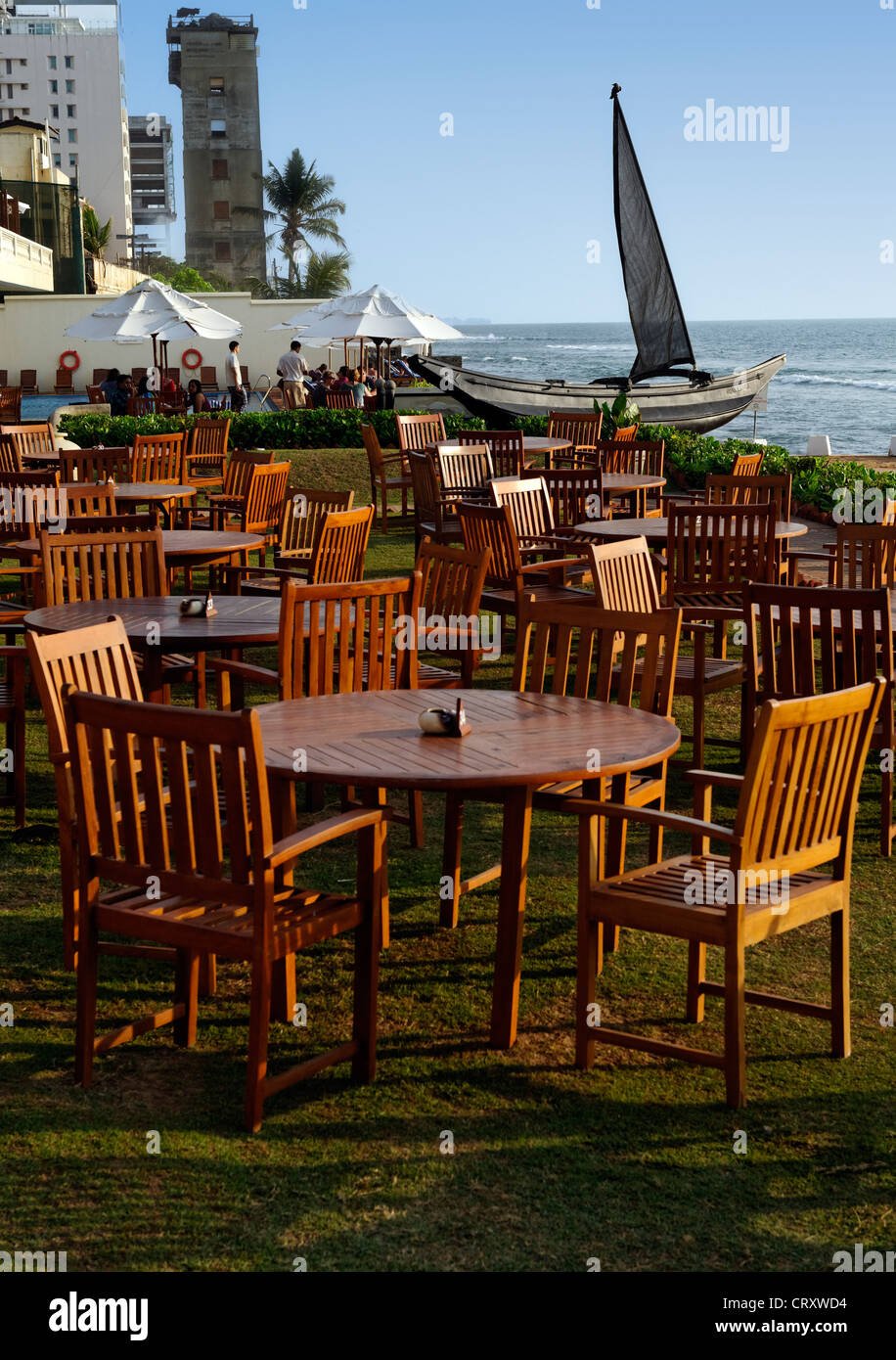 Tables of the Galle Face hotel on the gardens by the sea in Colombo, Sri lanka Stock Photo