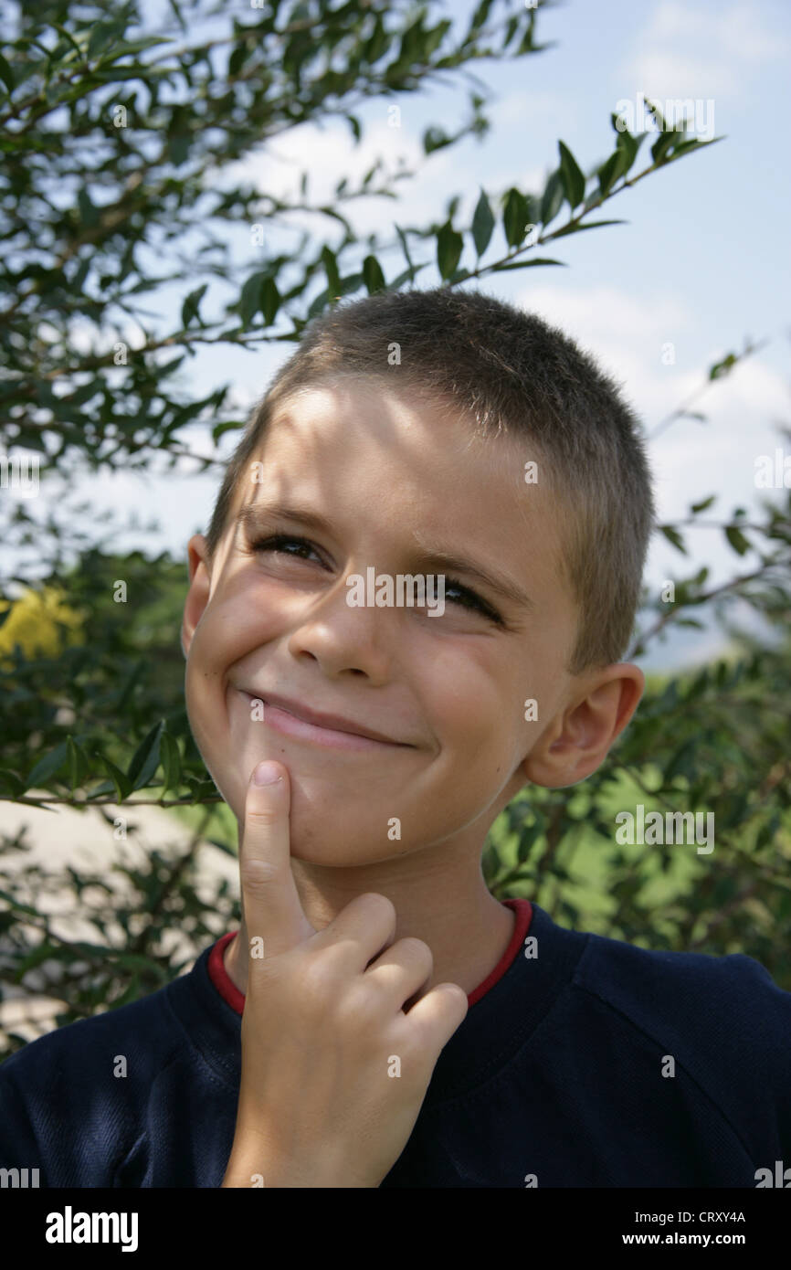 Seven years old boy, thinking. Stock Photo