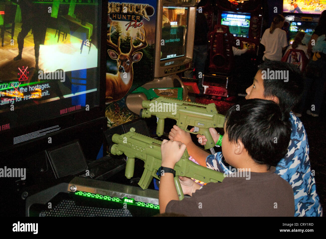 Arcades In Mn >> Asian American Boys Age 7 Playing Arcade Electronic Video Rifle Game Arcades In Mn >> Asian American Boys Age 7 Playing Arcade Electronic Video Rifle Game