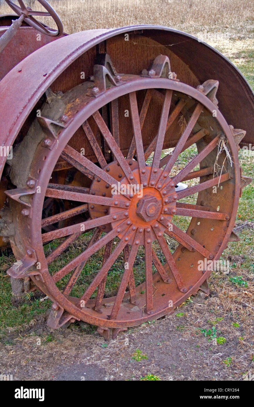 Rear spiked tire of antique tractor on display near a farm. Ottertail Minnesota MN USA Stock Photo