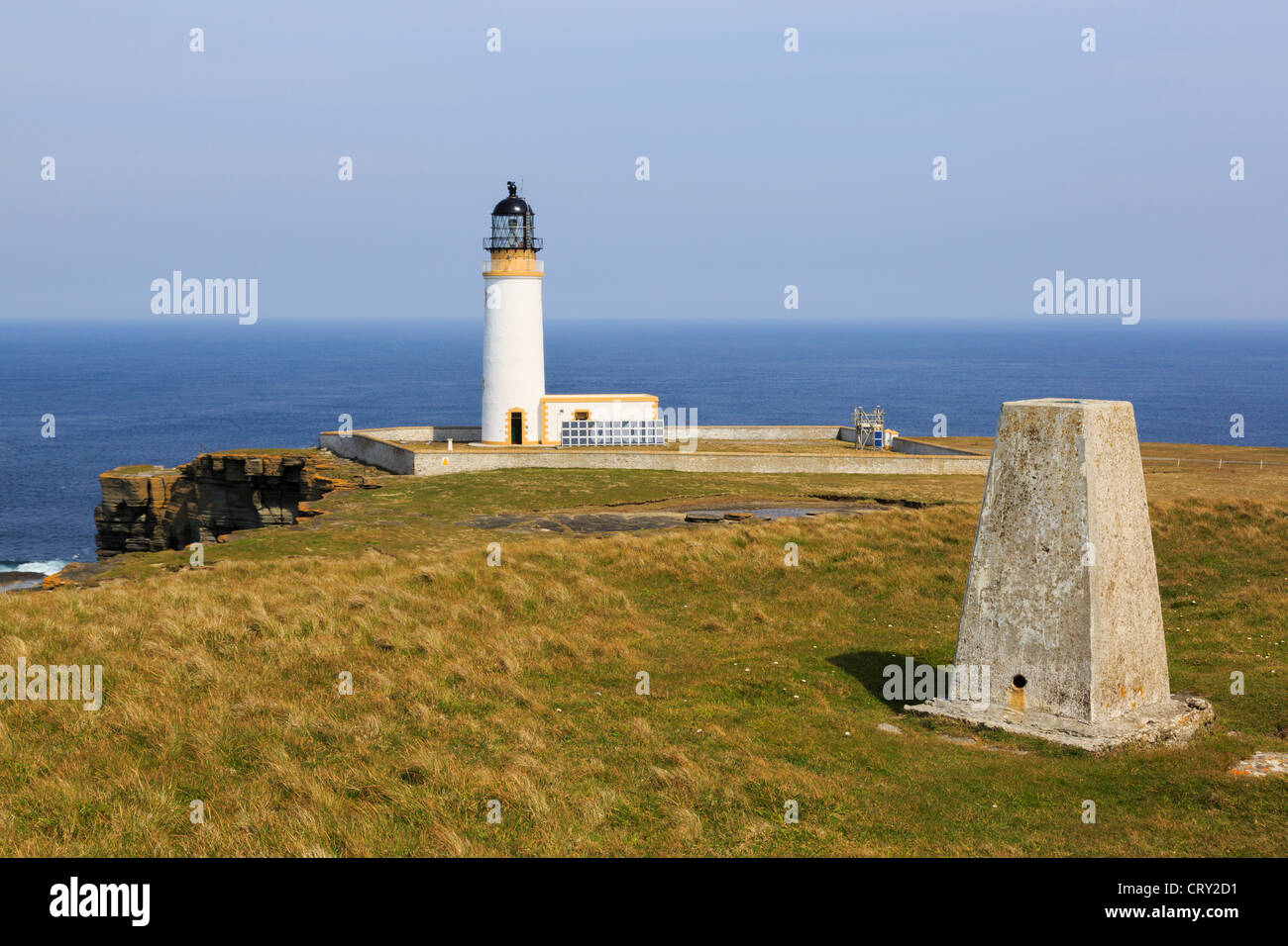Trig point and lighthouse built on headland to warn ships off North Shoal at Noup Head, Westray Island, Orkney Islands, Northern Isles, Scotland, UK Stock Photo