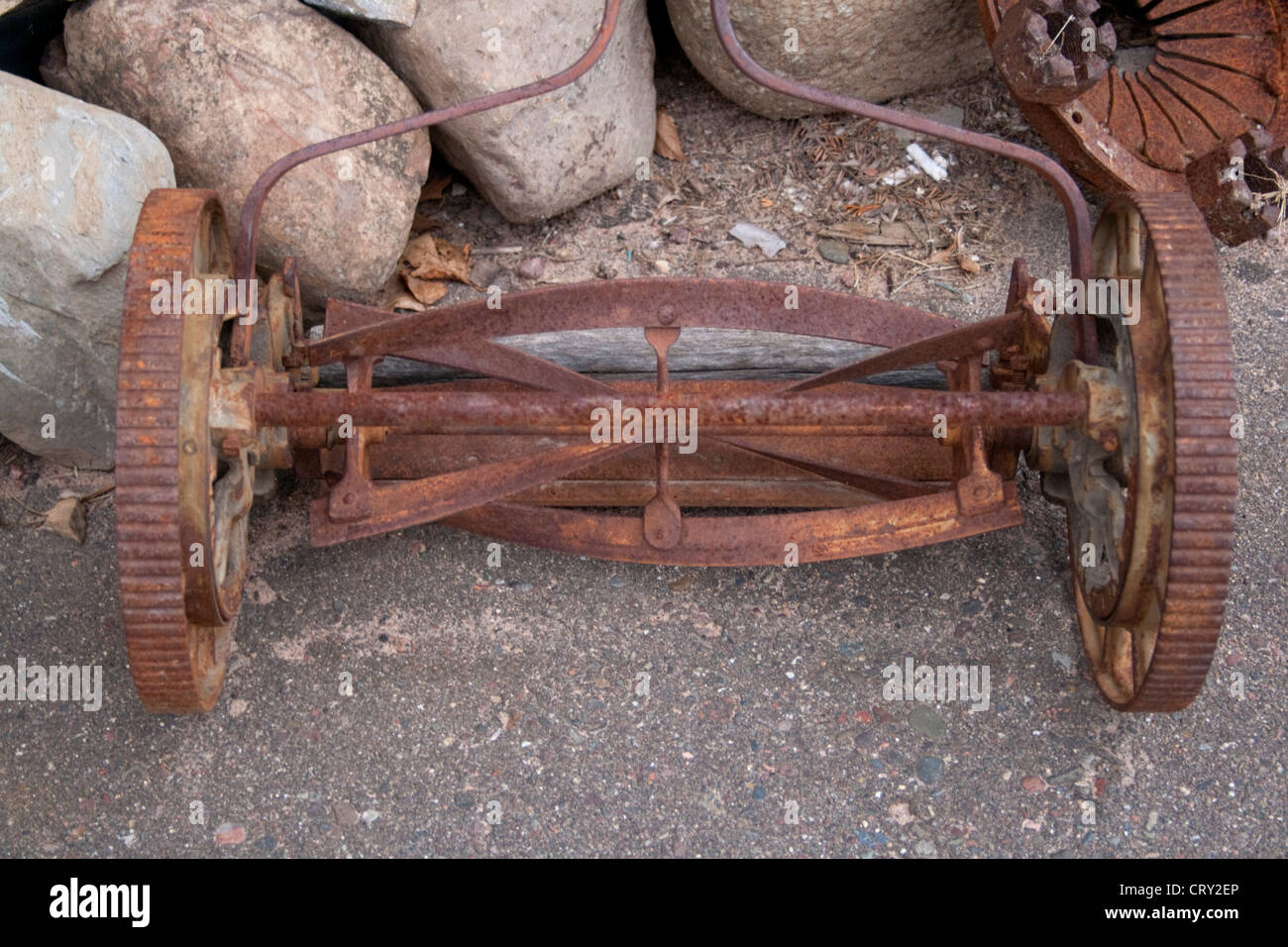 Rusted antique reel style lawn mower. Business and Industrial Park. Shell Lake Wisconsin WI USA Stock Photo