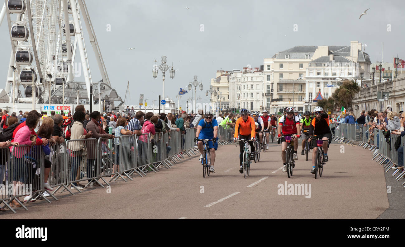 Cyclists coming to the finish line of the London to Brighton Charity Cycle ride; Brighton Sussex UK Stock Photo