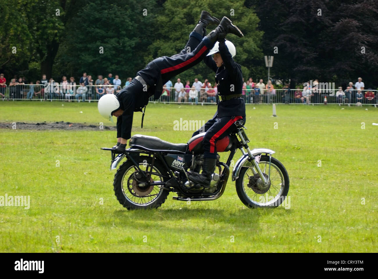 White Helmets Royal Signals Motorcycle Display Team riders performing in Coopers Field, Cardiff on Armed Forces Day, 2012 Stock Photo