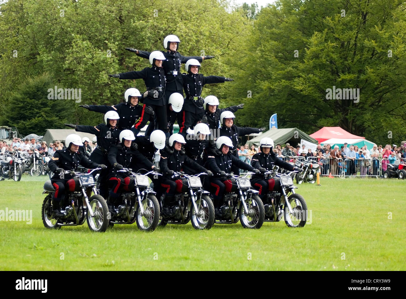 White Helmets Royal Signals Motorcycle Display Team riders performing in Coopers Field, Cardiff on Armed Forces Day, 2012 Stock Photo