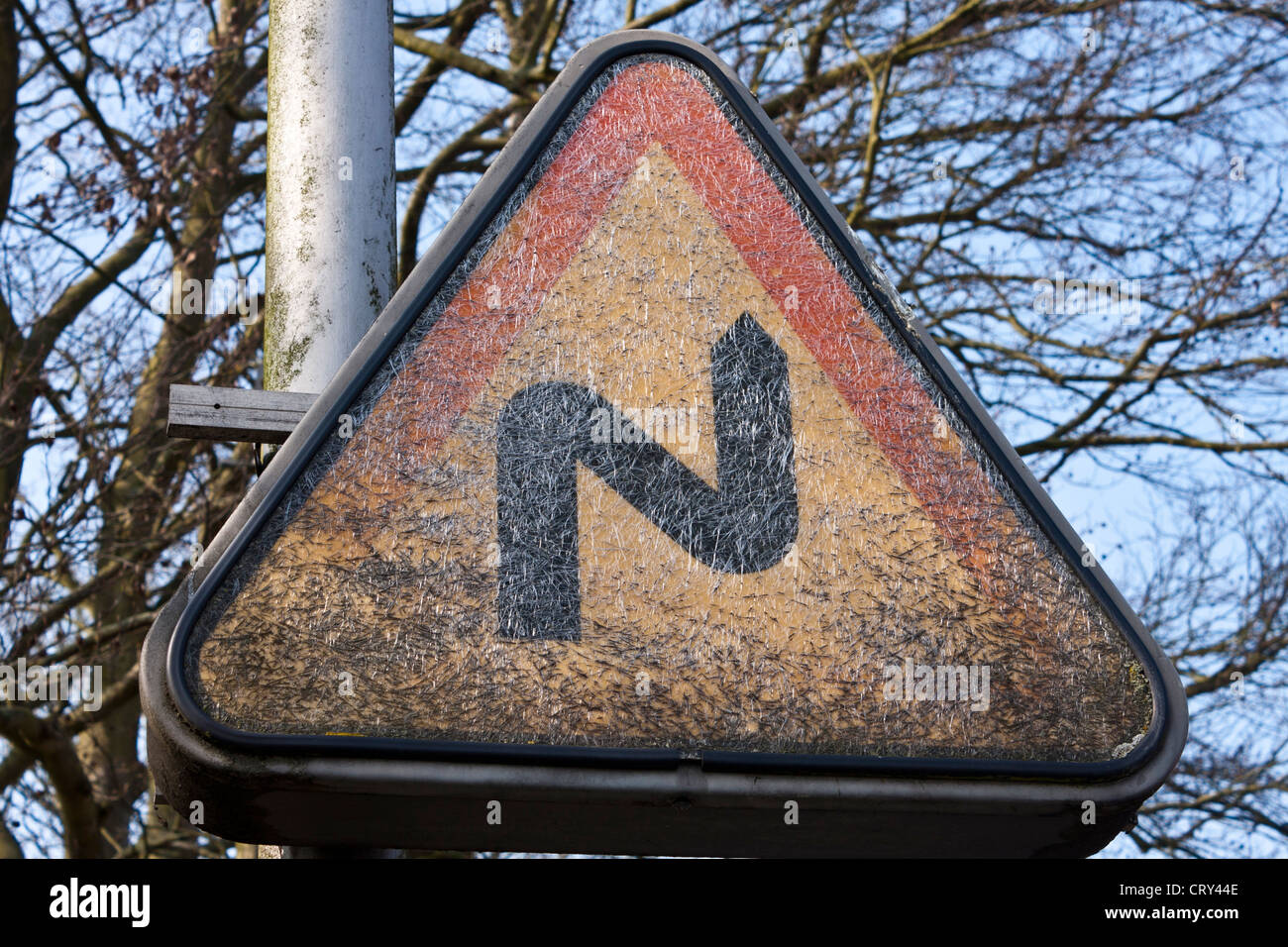 Road sign warning of sharp bends ahead Stock Photo
