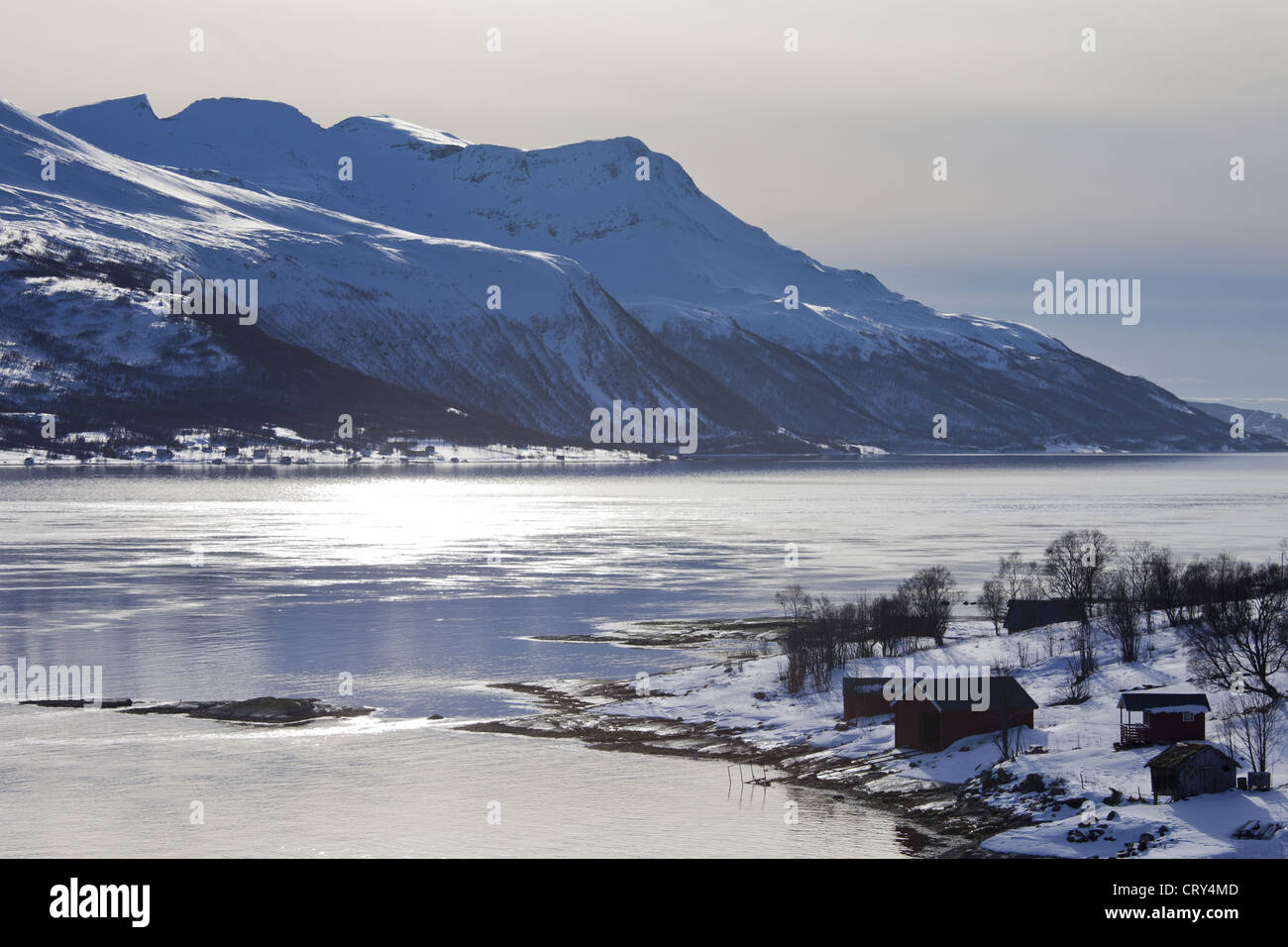 View across Tromso Sound to Tromso and the Lyngen Alps from Kvaloya Island in Arctic Circle Northern Norway Stock Photo
