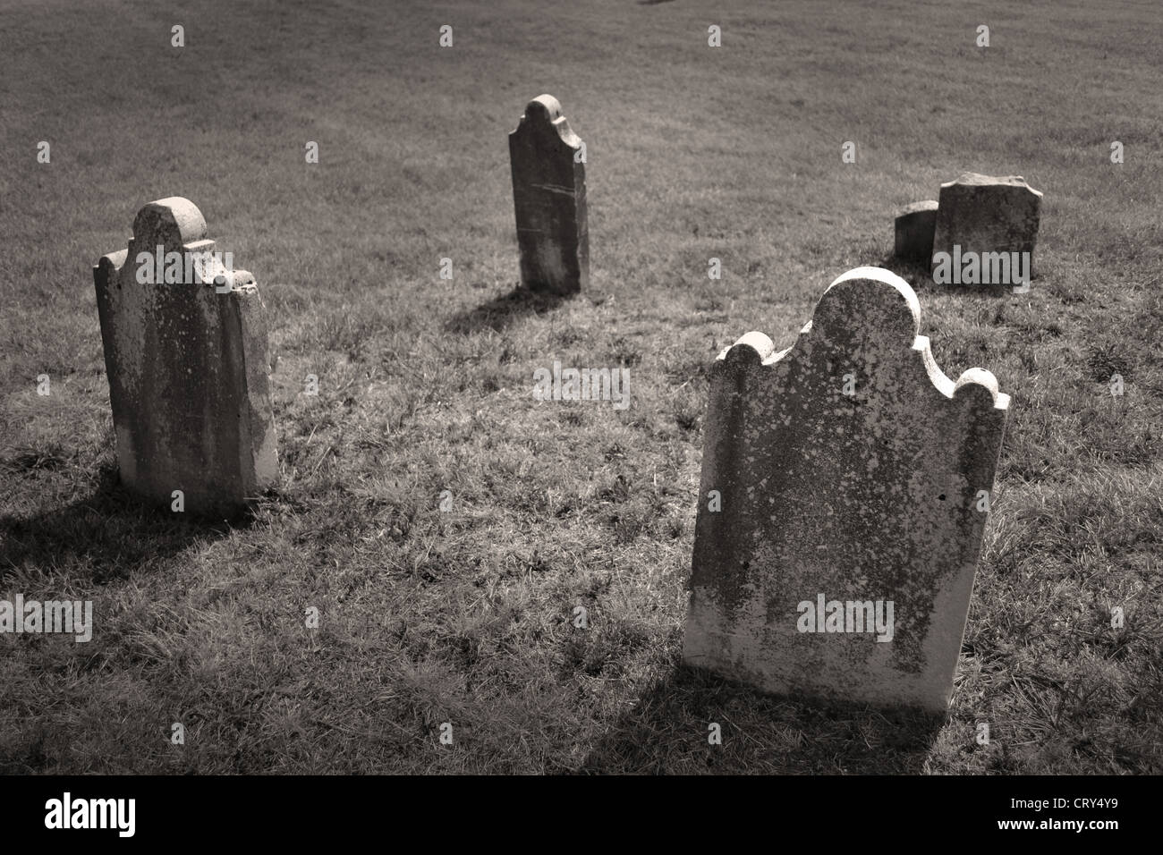 Grave yard with grave stones sitting alone on a hillside Stock Photo