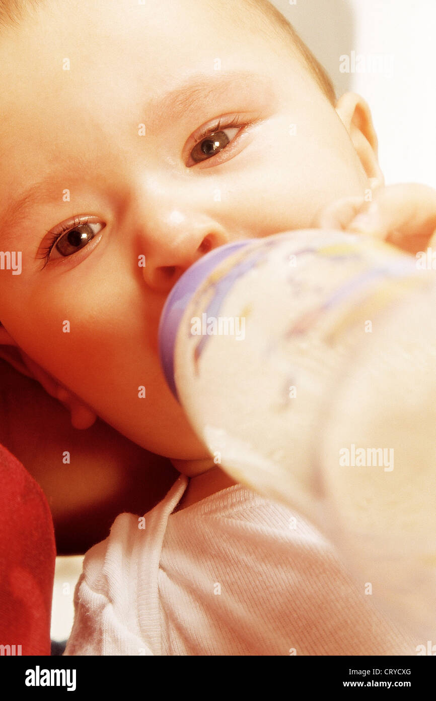 INFANT DRINKING FROM BABY BOTTLE Stock Photo Alamy