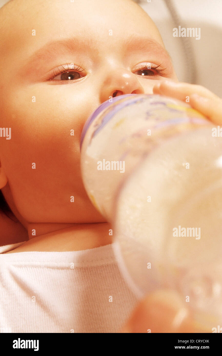 INFANT DRINKING FROM BABY BOTTLE Stock Photo Alamy