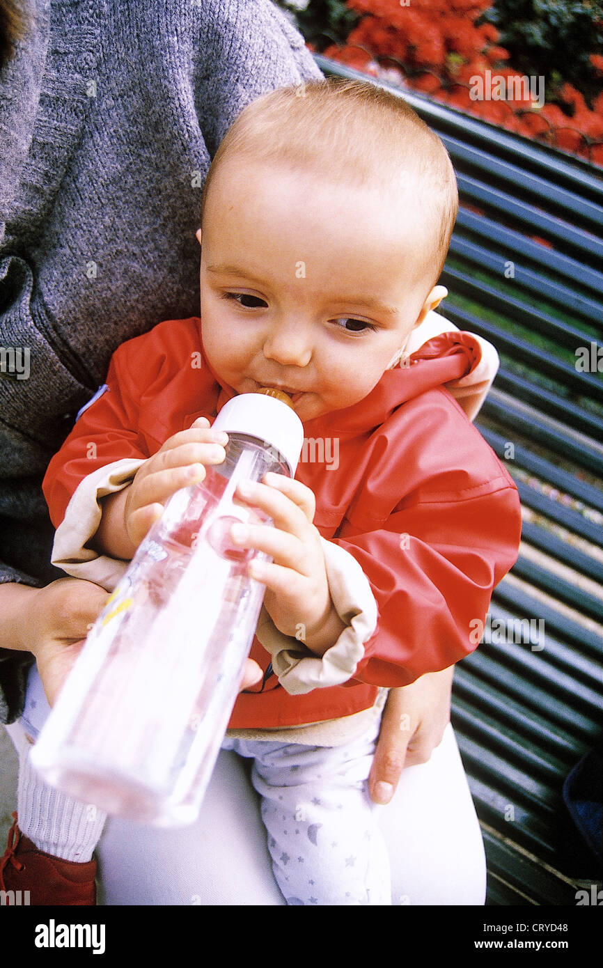 INFANT DRINKING FROM BABY BOTTLE Stock Photo Alamy