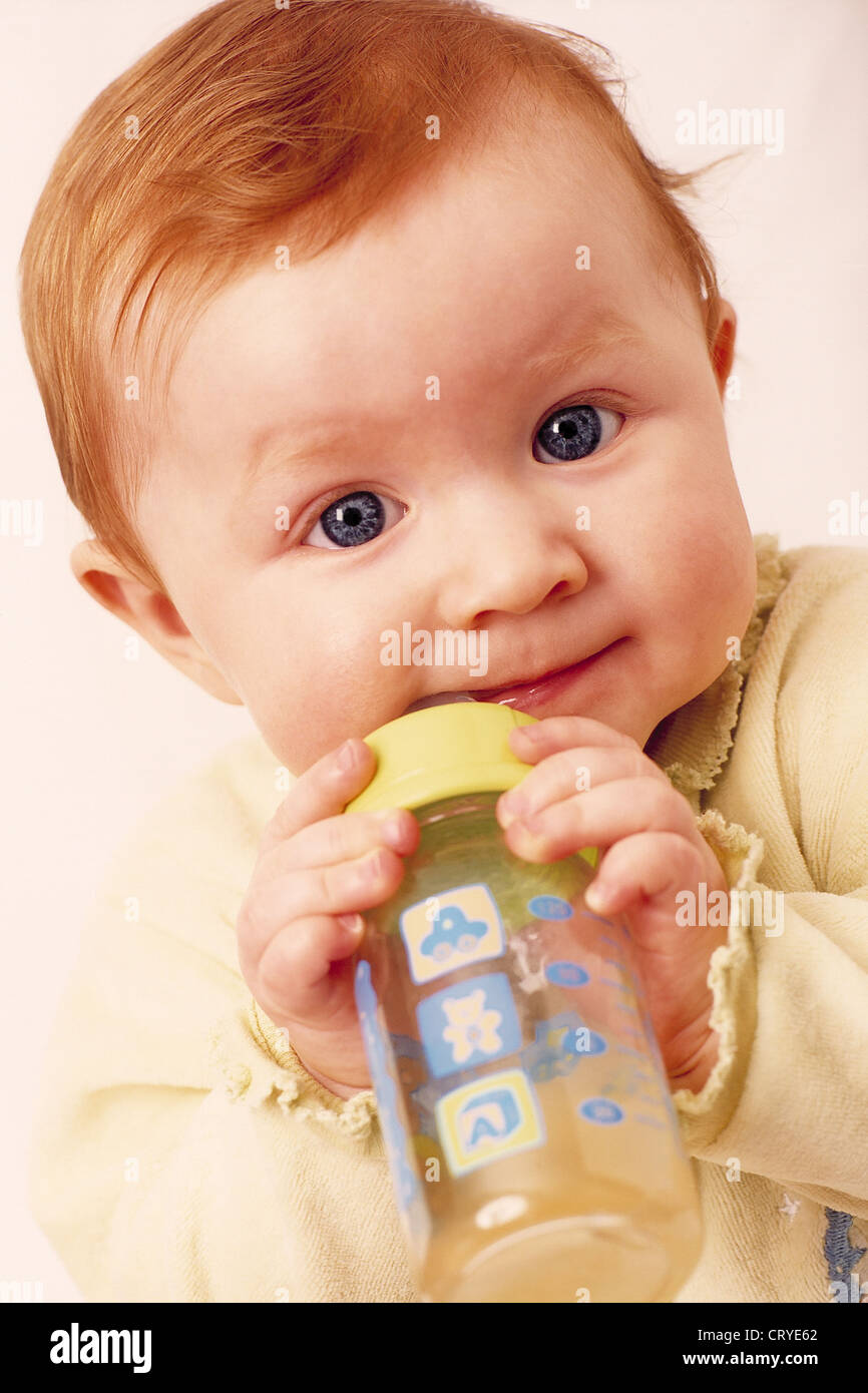 INFANT DRINKING FROM BABY BOTTLE Stock Photo Alamy