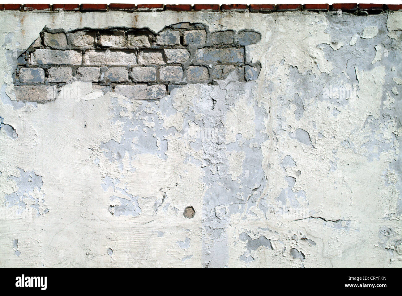 Old house wall with crumbling plaster Stock Photo