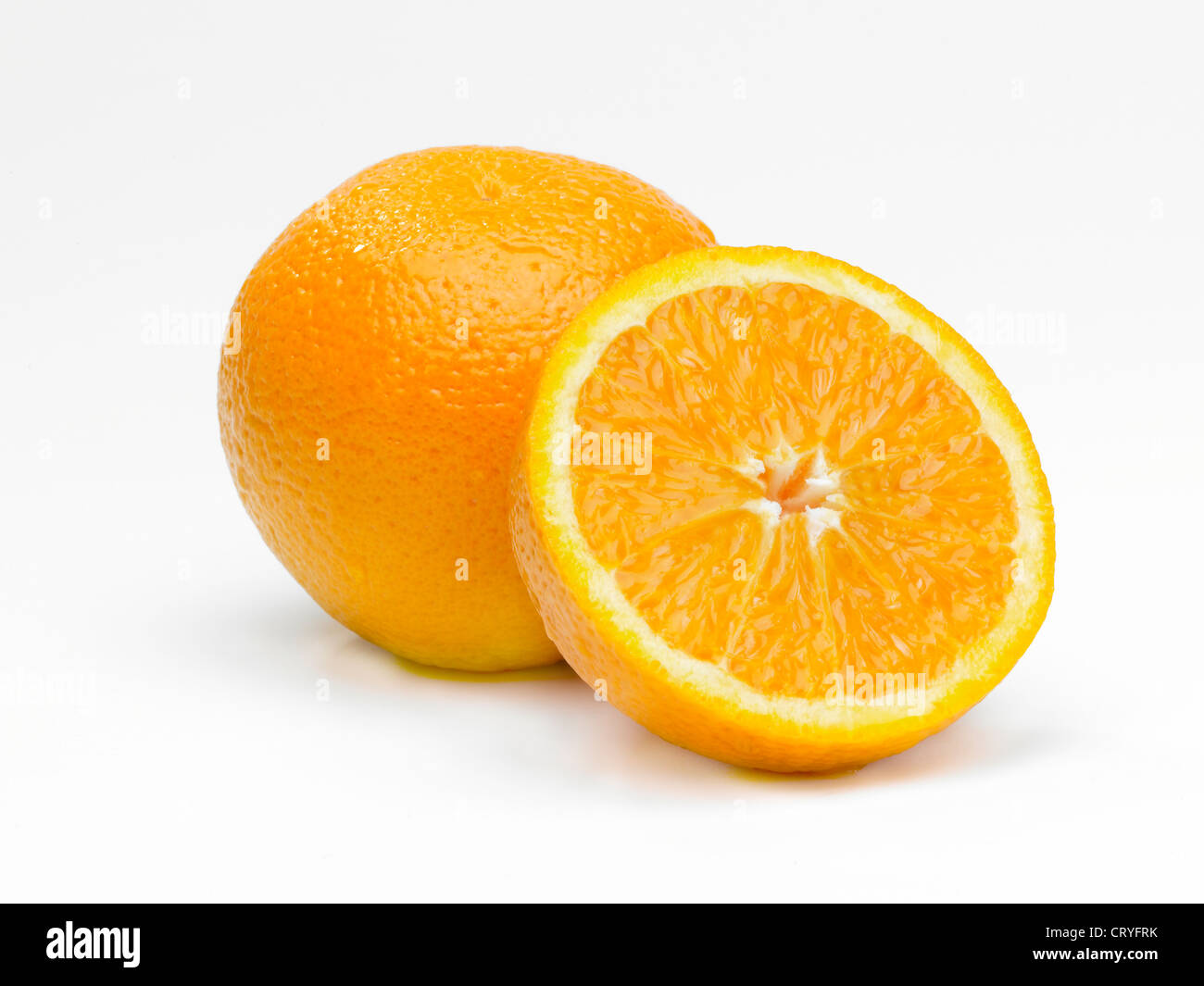 A whole and sliced half orange arrangement Stock Photo