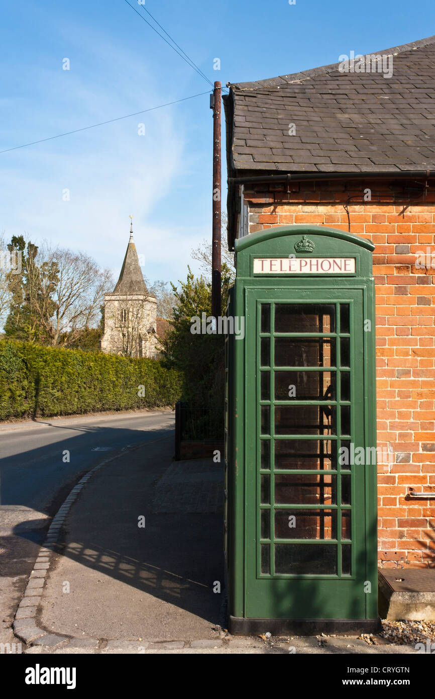 Green telephone box in English village Stock Photo