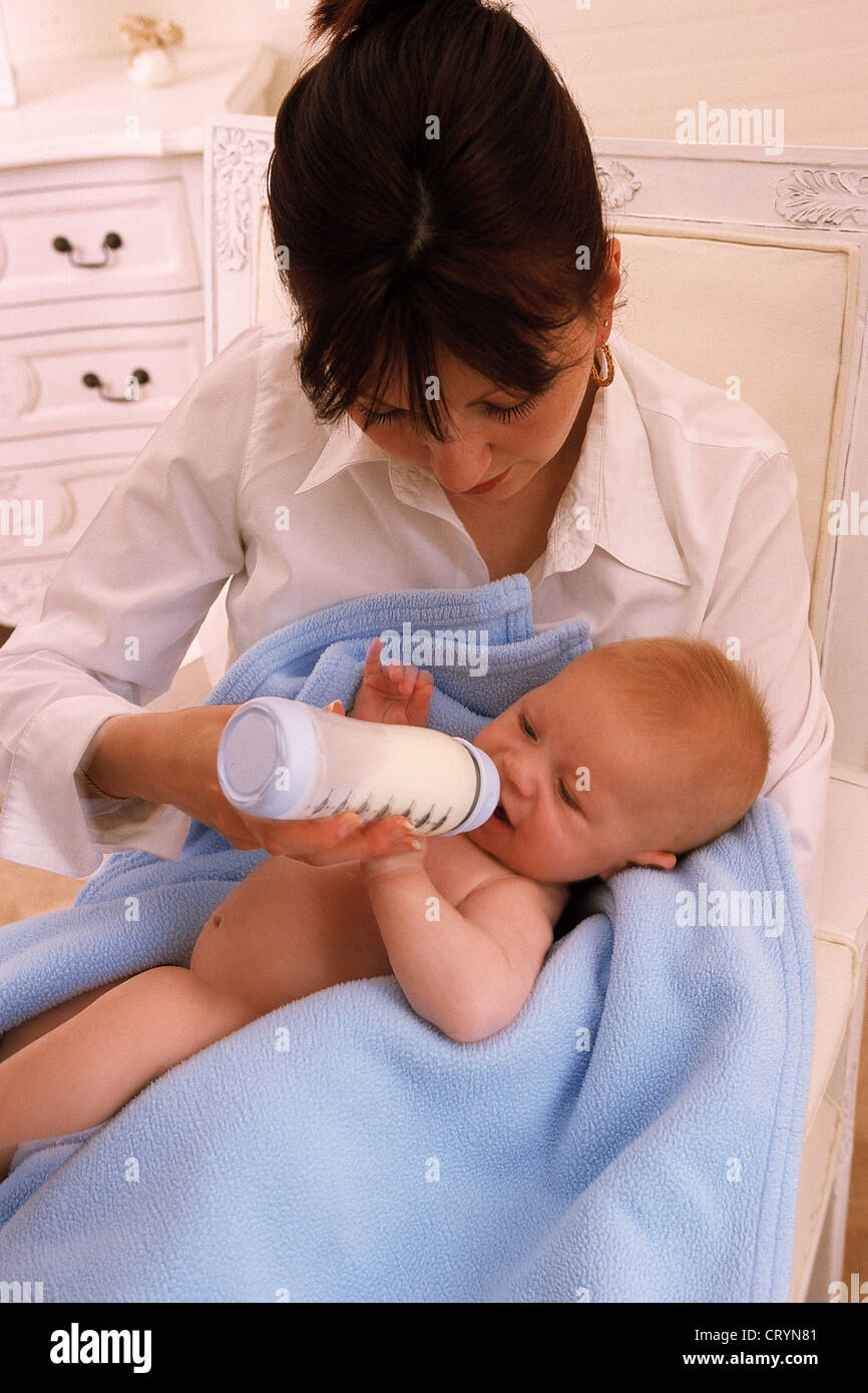 INFANT DRINKING FROM BABY BOTTLE Stock Photo Alamy