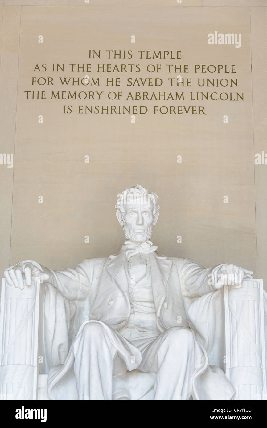 WASHINGTON DC, United States — The iconic statue of a seated President Abraham Lincoln, sculpted by Daniel Chester French, is prominently displayed inside the Lincoln Memorial on the National Mall. This front view shows Lincoln gazing eastward towards the Washington Monument and the U.S. Capitol, embodying his enduring presence in American history and politics. Stock Photo