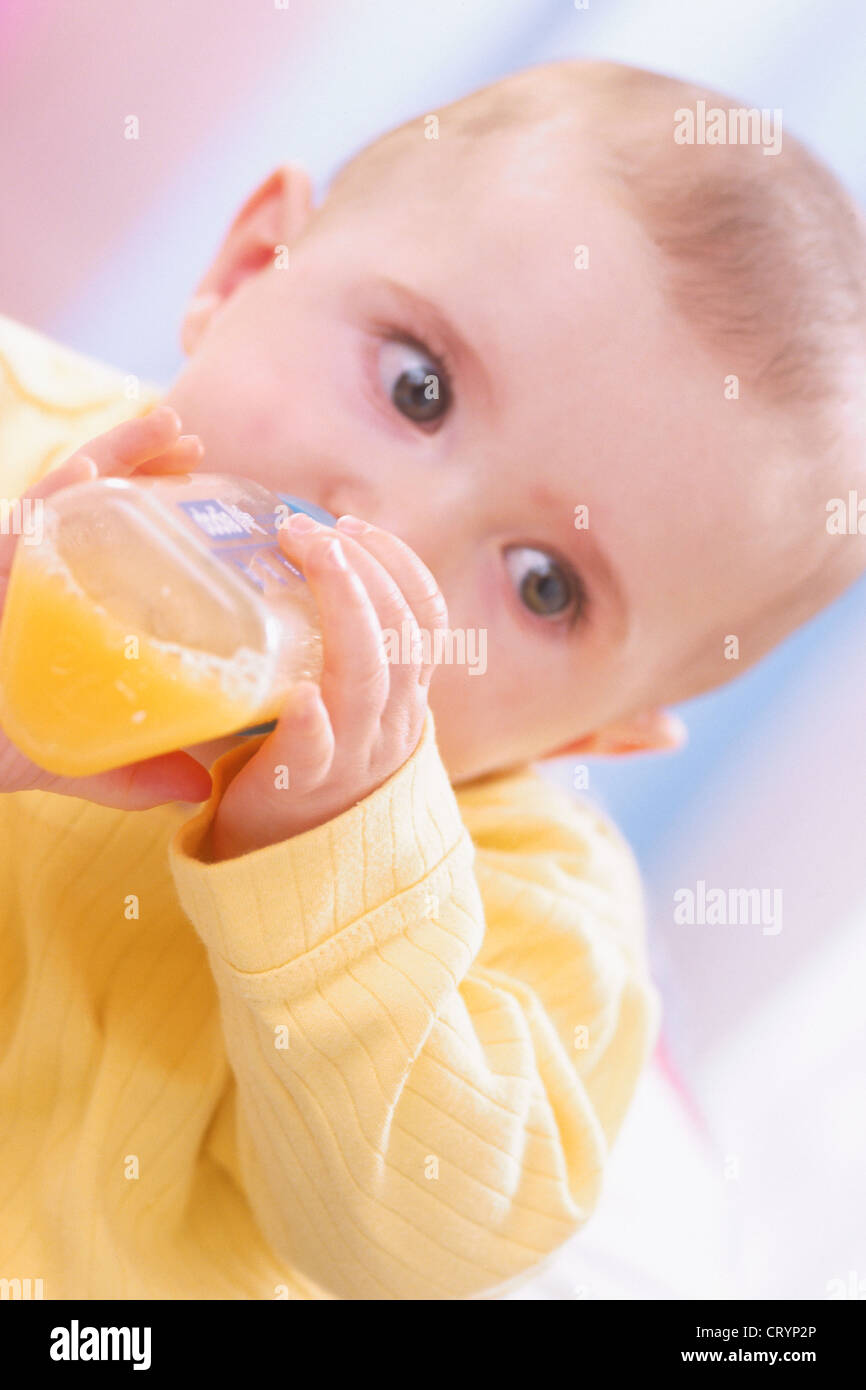 INFANT DRINKING FROM BABY BOTTLE Stock Photo Alamy