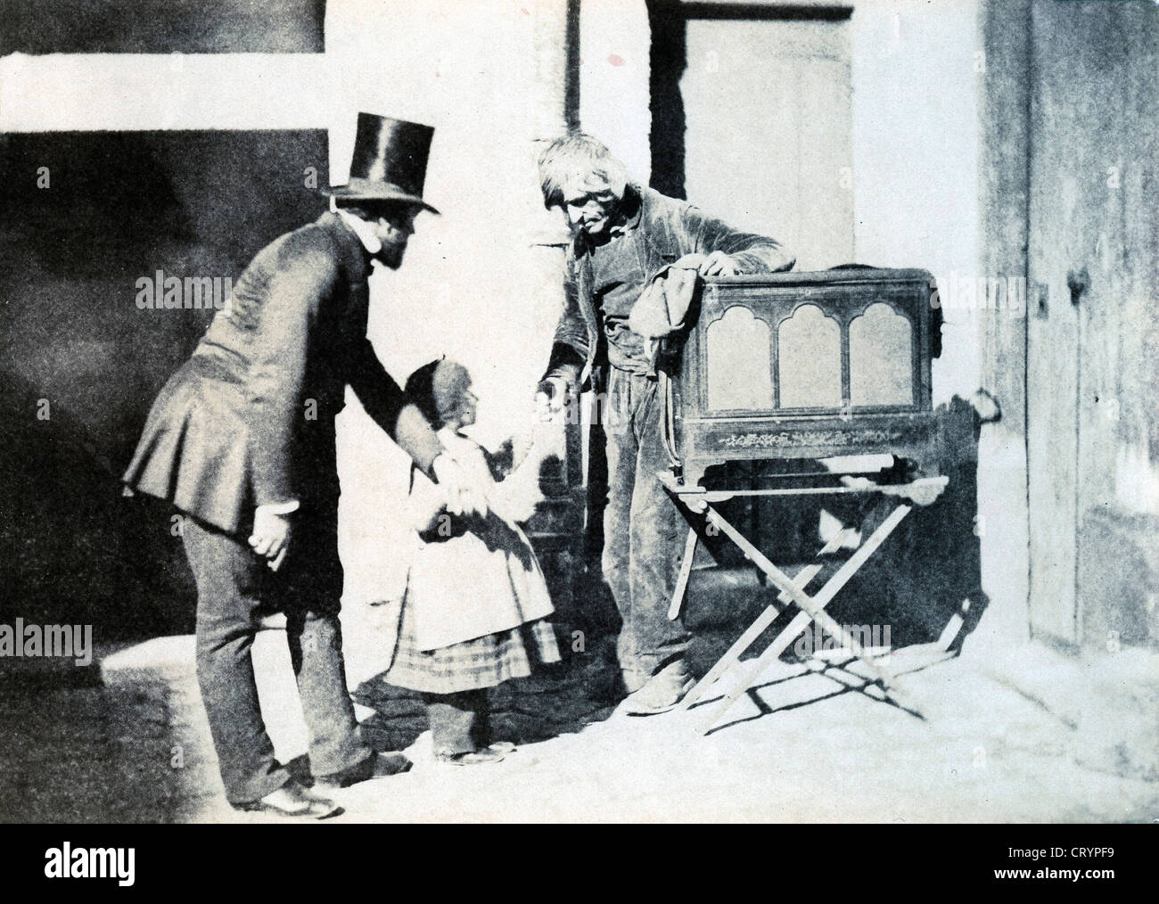 Henri Le Secq and a Child Giving Alms to an Organ Grinder, 1853, Charles Negre Stock Photo