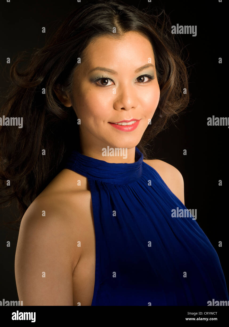 Asian woman in blue velvet evening dress Stock Photo - Alamy