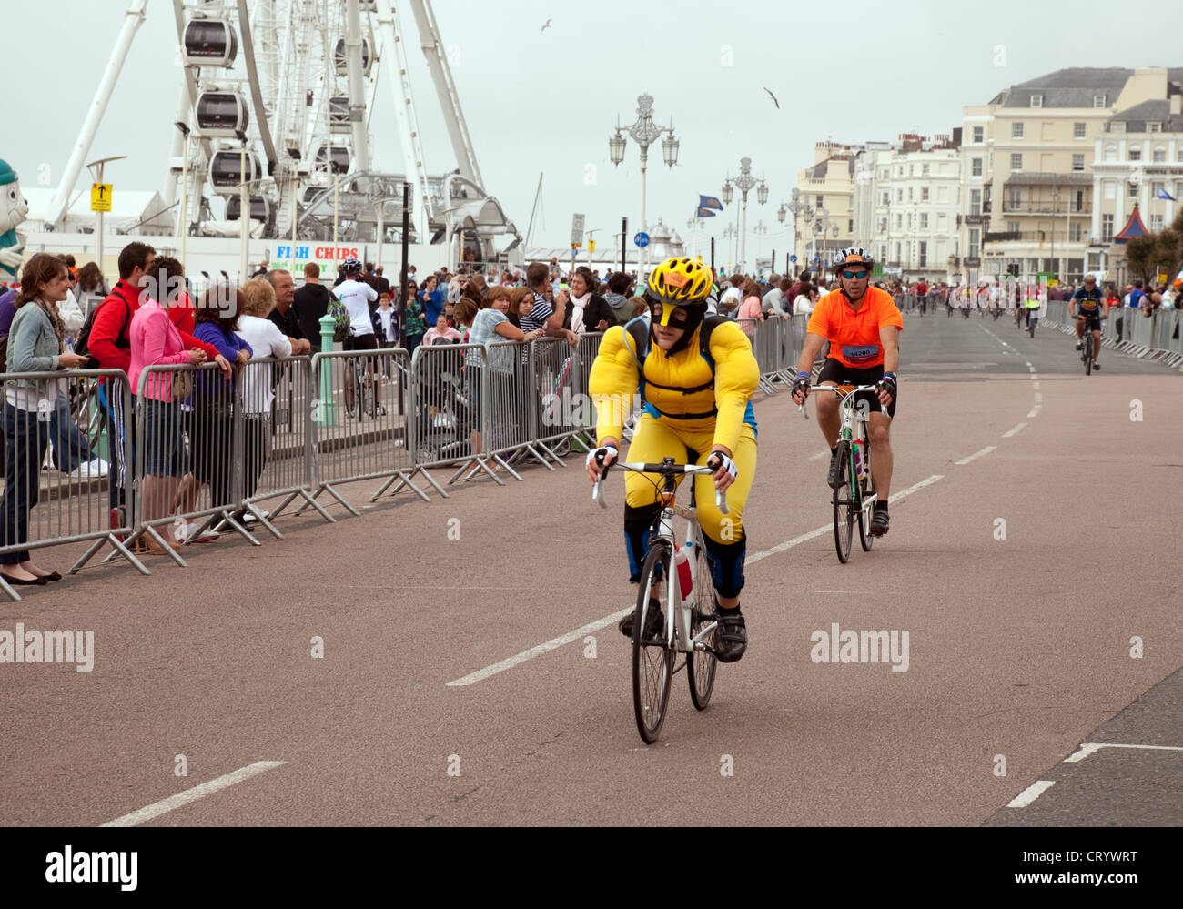 A man in funny costume finishing the London to Brighton Charity cycle ride, Brighton Sussex UK Stock Photo