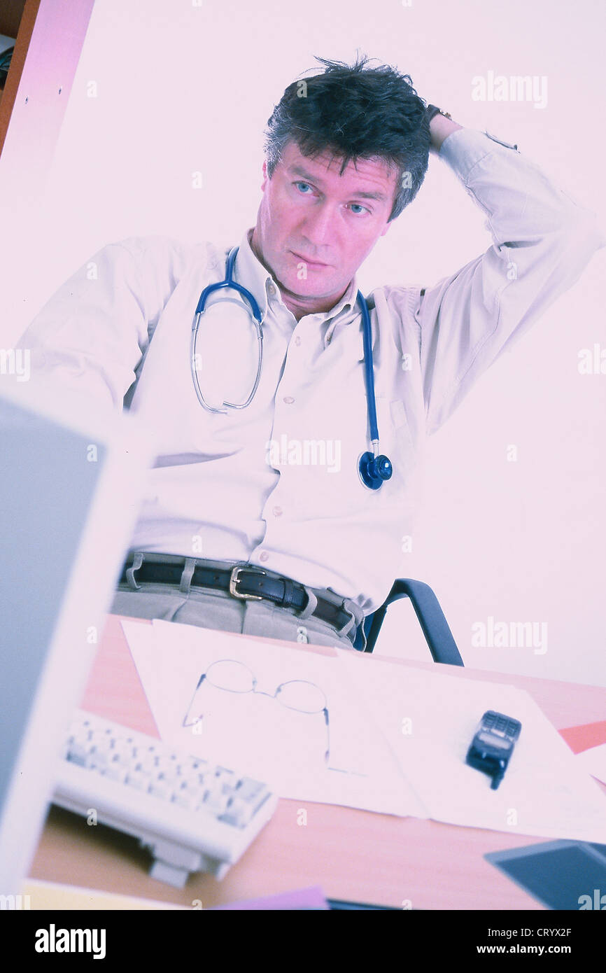 Tired doctor at computer hi-res stock photography and images - Alamy