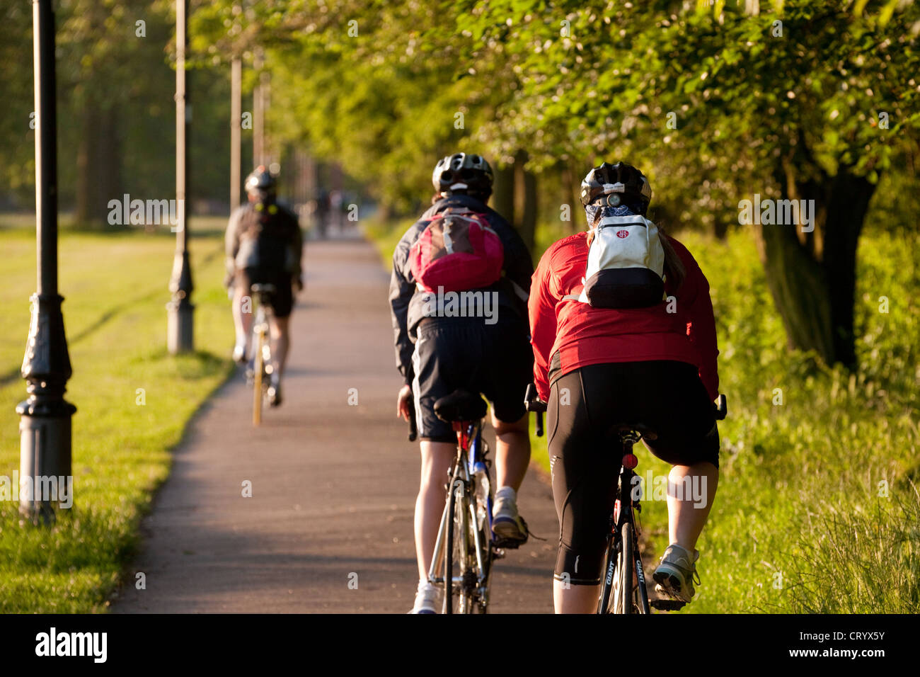 People cycling in Clapham Common on a June morning, London UK Stock Photo