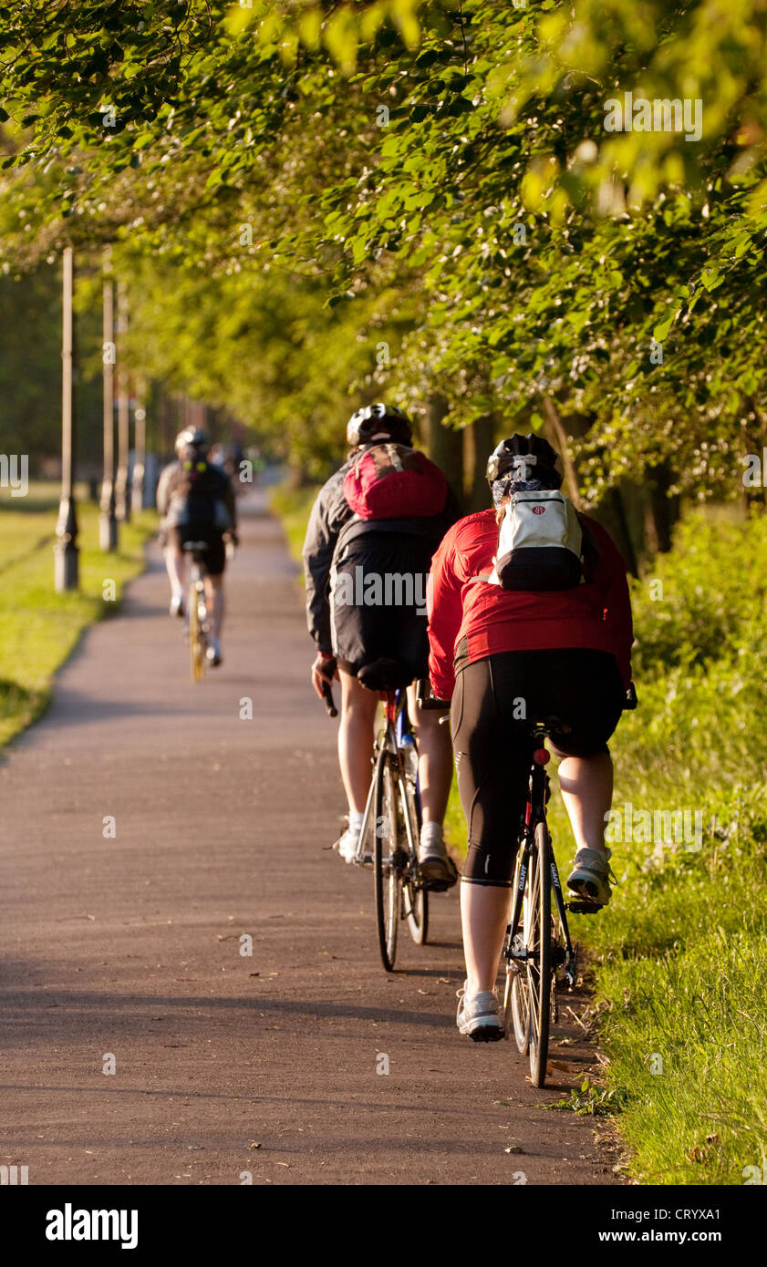 People cycling in Clapham Common on a June morning, London UK Stock Photo