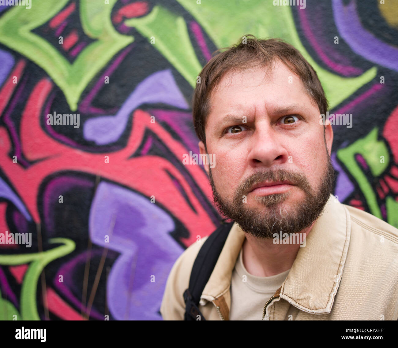 Man with stern face looks towards camera. Stock Photo