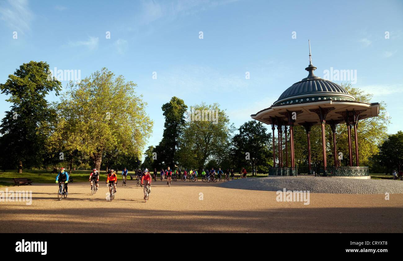 Riders cycling by the bandstand, Clapham Common; the charity London to Brighton cycle ride, UK Stock Photo