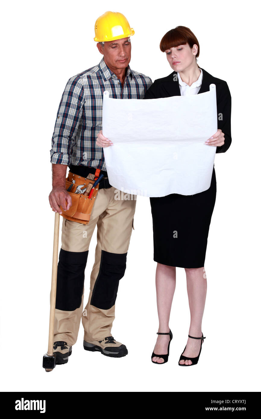 craftsman and businesswoman looking at a blueprint Stock Photo - Alamy